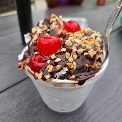 Sundae with chocolate sauce, chopped nuts and cherries